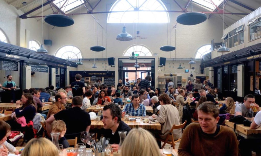 People enjoying Altrincham Market's food hall offer